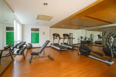 a gym with a bunch of exercise equipment in it at Central Modern Cosy Condo in Makati - The Linear Suite in Manila