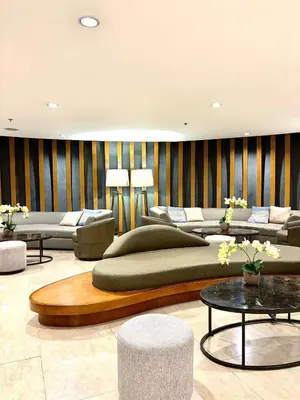 a living room with couches and tables and chairs at Shore Condotel pasay manila in Manila