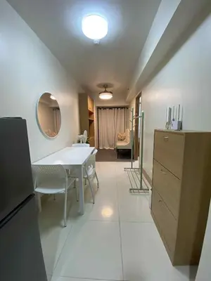 a kitchen with a table and a dining room at Shore Condotel pasay manila in Manila