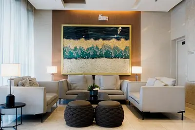 a living room with couches and a painting on the wall at Blue Horizon - Newly renovated condo near MOA in Manila
