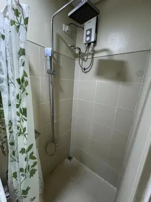 a shower in a bathroom with a shower curtain at Lemon Room in S Residences near MOA, Airport, US Embassy by Prime Stay in Manila