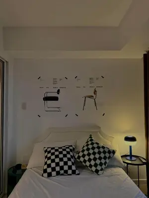 a bedroom with a bed with black and white pillows at Room at SM Bicutan GJ in Manila