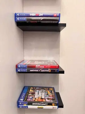 a stack of video games sitting on a shelf at A2Z Staycation Miami Tower 15th Floor With Ps4 and Netflix in Manila