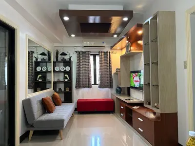 a living room with a couch and a tv at Spacious 2 Bed & 2 Bath Condo in Newport City in Manila