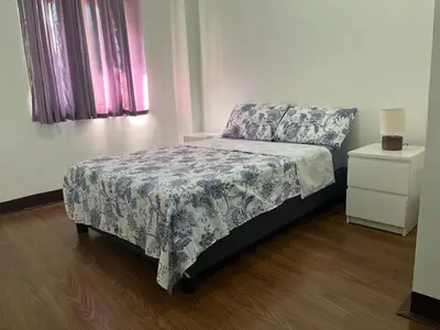 a bedroom with a bed and a dresser with a bedspread at Spacious 2 Bed & 2 Bath Condo in Newport City in Manila