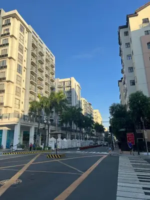an empty street in a city with tall buildings at Spacious 2 Bed & 2 Bath Condo in Newport City in Manila