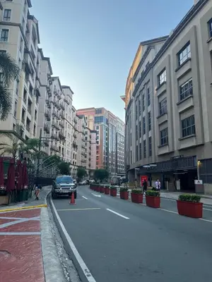 a car driving down a city street with buildings at Spacious 2 Bed & 2 Bath Condo in Newport City in Manila