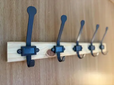 a wooden shelf with four hooks on a wall at Elegant Stay in Shell Residences Tower A by One Guest Place in Manila