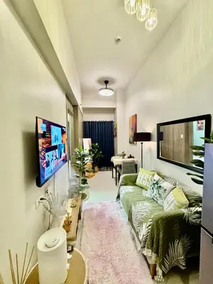 a living room with a couch and a tv at Mitch Ace Staycation in Manila