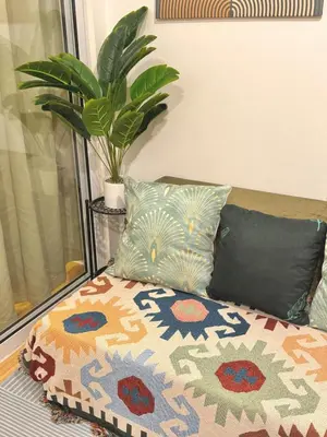 a bed with pillows and a plant in a room at 1BR with Pool View Near NAIA Long Stay Ready in Manila
