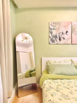 a bedroom with a mirror next to a bed at 1BR with Pool View Near NAIA Long Stay Ready in Manila