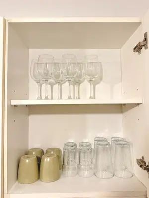 a row of wine glasses sitting on a shelf at 1BR with Pool View Near NAIA Long Stay Ready in Manila