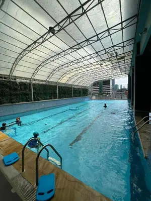 a large swimming pool with a large ceiling at A Venue Residences 1509 in Makati