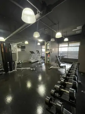 a gym with several rows of tread machines and lights at A Venue Residences 1509 in Makati