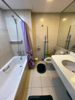 a bathroom with a tub and a toilet and a sink at Antel Spa Residences 9D in Makati