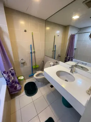 a bathroom with a sink and a toilet at Antel Spa Residences 9D in Makati