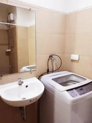 a bathroom with a toilet and a sink at My little Apartment in Manila