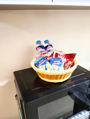 a basket of marshmallows and chips on top of a microwave at Studio Near Mall & Airport! in Manila