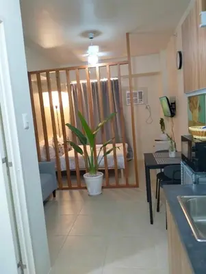 a kitchen with a potted plant in a room at Studio Near Mall & Airport! in Manila