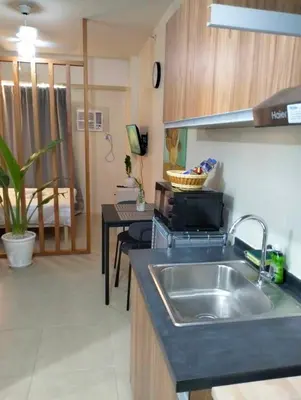 a kitchen with a sink and a counter top at Studio Near Mall & Airport! in Manila