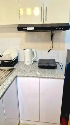 a kitchen with a counter top with a coffee pot on it at 1BR with Netflix, Prime & KTV in Manila