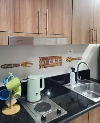 a kitchen with a sink and a counter top at Mall of Asia condotel shore 3 in Manila