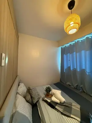 a bedroom with a bed with a potted plant on it at City View Facing Moa in Manila