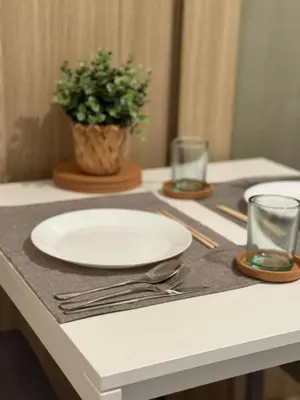 a table with a plate and a potted plant on it at City View Facing Moa in Manila