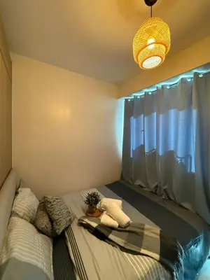 a bedroom with a bed with a potted plant on it at City View Facing Moa in Manila