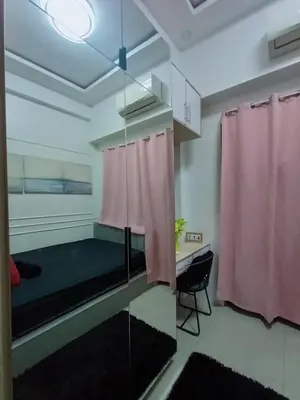 a room with a bed and a pink curtain at Cozy Couple Room in Manila