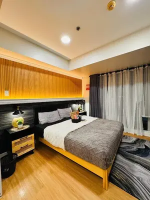 a bedroom with a large bed and a window at Condo Azure Urban Resort Paranaque in Manila