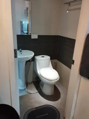 a small bathroom with a toilet and a sink at Urban Nest in Manila