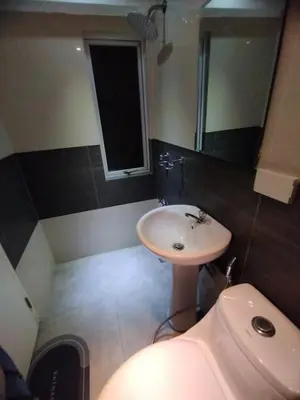 a bathroom with a sink and a mirror at Urban Nest in Manila