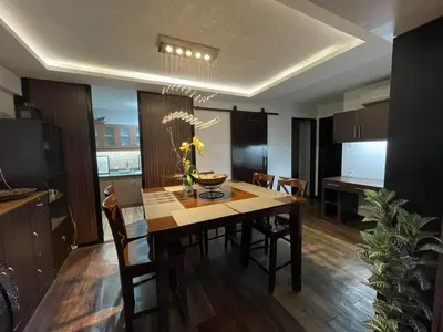 a kitchen and dining room with a table and chairs at Spacious 3BR with Huge TV near BGC Makati Airport in Manila