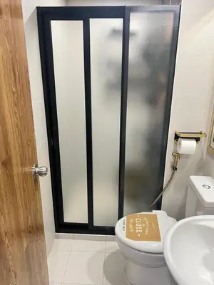 a bathroom with a shower with a toilet and a sink at Azure Urban Resort paranaque in Manila