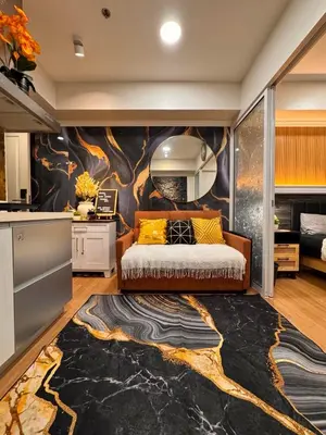 a bedroom with a bed and a wall with a mural at Azure Urban Resort paranaque in Manila