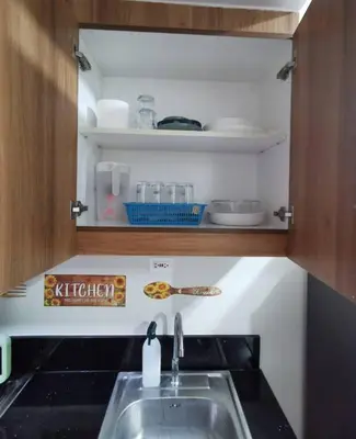 a kitchen with a sink and a counter top at Mall of Asia condotel shore 3 tower 2 in Manila