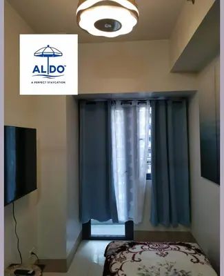 a bedroom with a bed and a window at Mall of Asia condotel shore 3 tower 2 in Manila