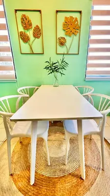 a white table with a potted plant on top of a room at Enchanted Home - Near Enchanted Kingdom in Santa Rosa