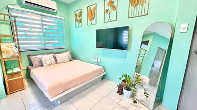 a bedroom with a bed and a mirror and a tv at Enchanted Home - Near Enchanted Kingdom in Santa Rosa
