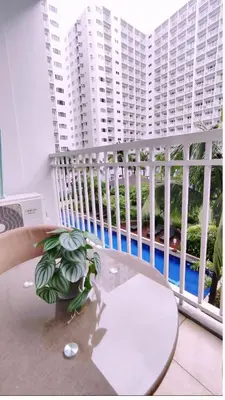 a table with a plant sitting on top of a balcony at Elegant with Best View Fast Wifi Mall of Asia Airport in Manila