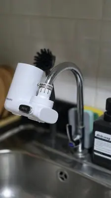 a kitchen sink with a coffee cup plugged into a faucet at Elegant with Best View Fast Wifi Mall of Asia Airport in Manila