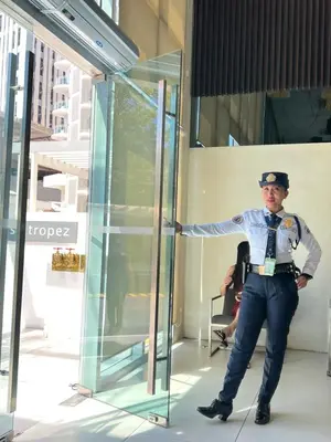 a man is standing in front of a glass door at Azure Urban Resort paranaque velvet horiyama in Manila
