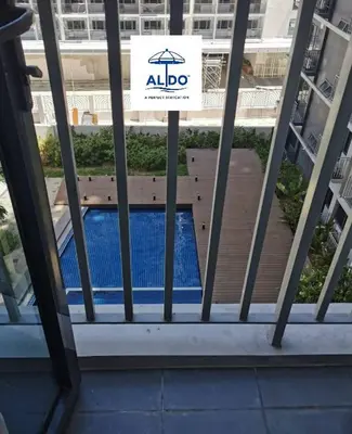 a sign on a window of a building with a swimming pool at Mall of Asia condotel shore 3 residence in Manila