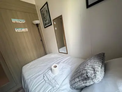 a bed with a roll of toilet paper on it at 2br Beach KTV Condo in MOA SMX Okada, Near Airport in Manila