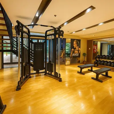 a gym with treadmills and benches in a room at Luxurious 3BR near Solaire & Okada w Infinity Pool in Manila