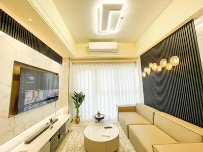 a living room with a couch and a tv at Luxurious 2BR near Solaire, Okada, Airport in Manila