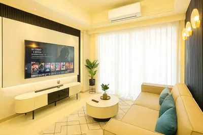 a living room with a couch and a tv at Ultra Luxury 6BR near Solaire, Okada, & Airport in Manila