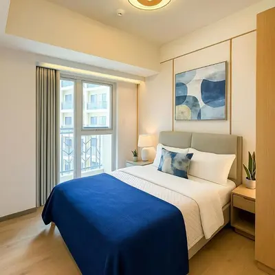 a bedroom with a large bed with a blue blanket at Spacious 3BR near Solaire, Okada, Airport I 8pax in Manila