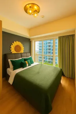 a bedroom with a large bed with a large window at Spacious 2BR near Solaire, Okada, Airport in Manila